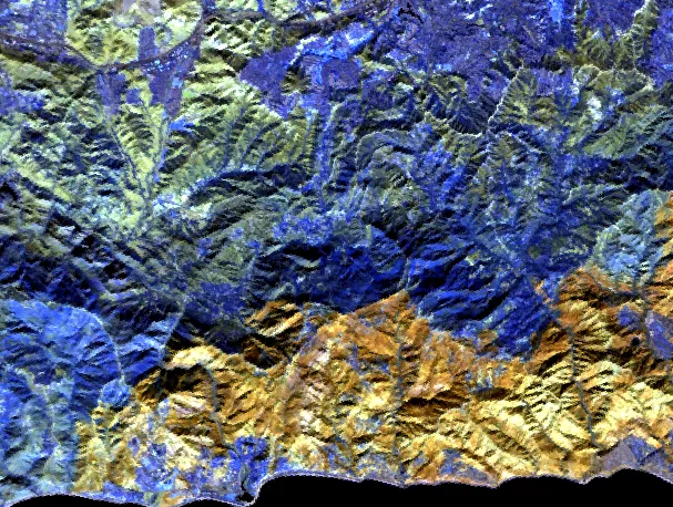 The same mountains in three shortwave-infrared bands. The upper slopes read deep blue and olive where vegetation remains; the lower half above the coast reads orange and gold. That region lies inside the perimeter of the Palisades fire two weeks earlier, and its edge is abrupt.